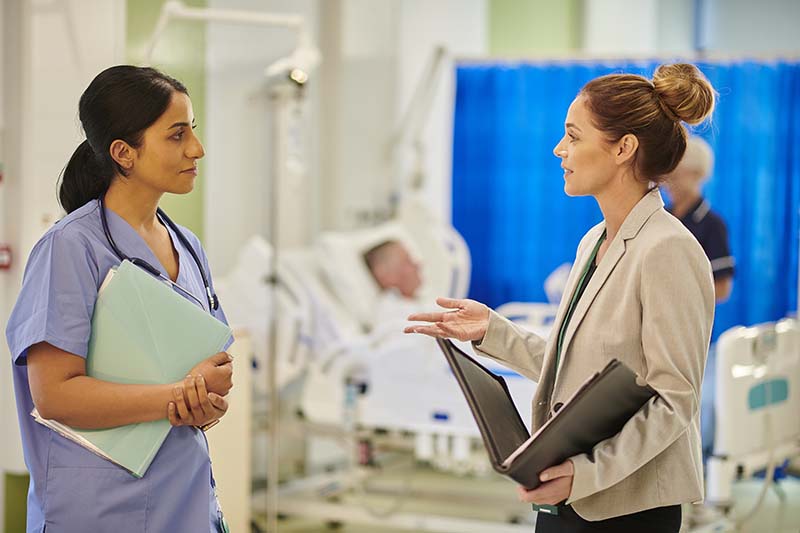 Two female medical professionals having a conversation