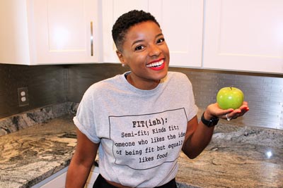 Smiling Healthy nurse healthy nation challenge participant holding green apple